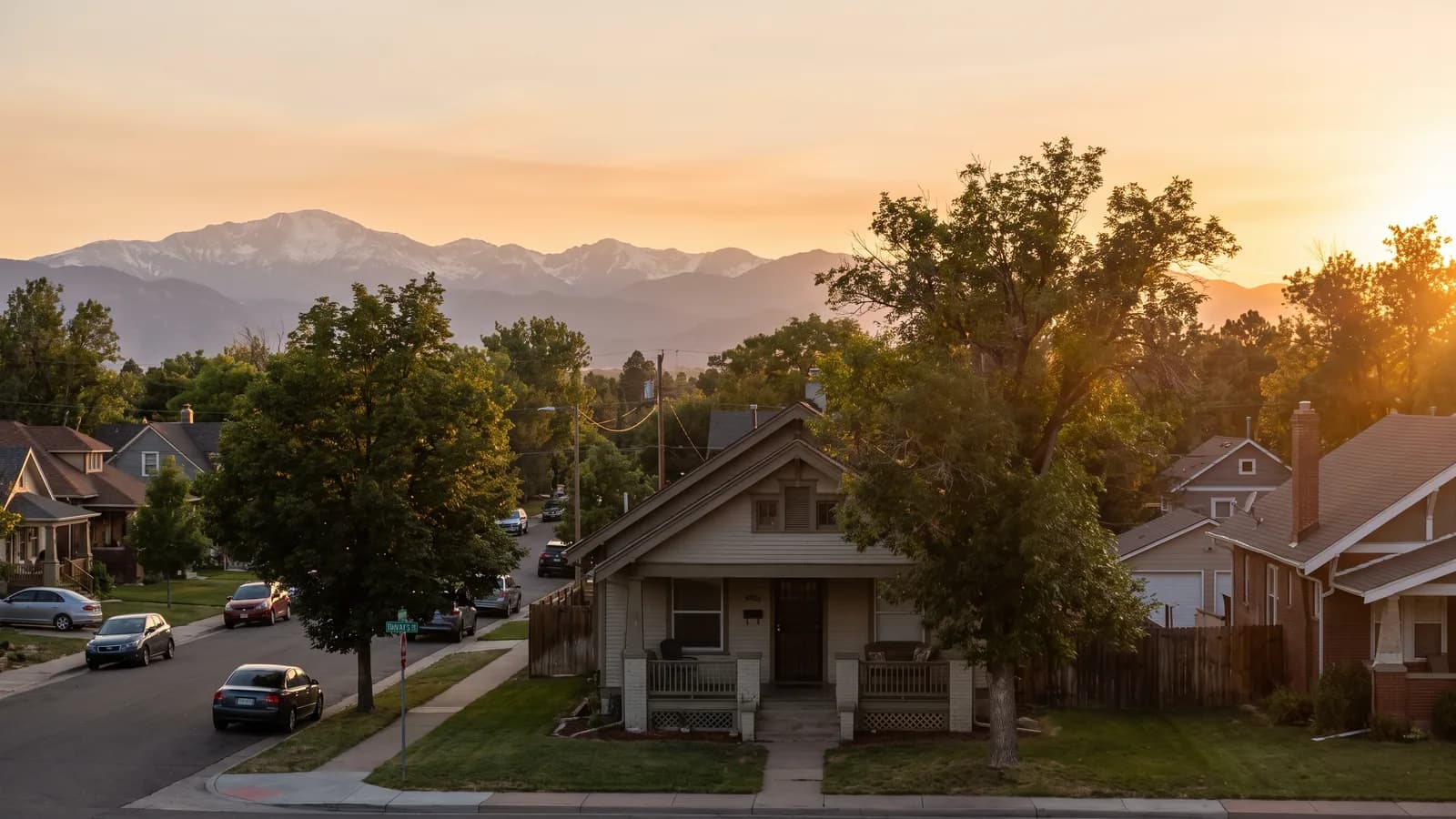 A single-family home in the Colorado Springs area with the Front Range mountains in the distance under warm afternoon light