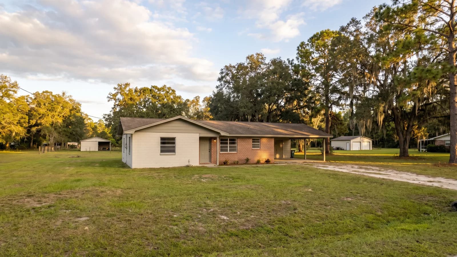 A rural-suburban single-family home on a larger lot in unincorporated Polk County in warm daylight.