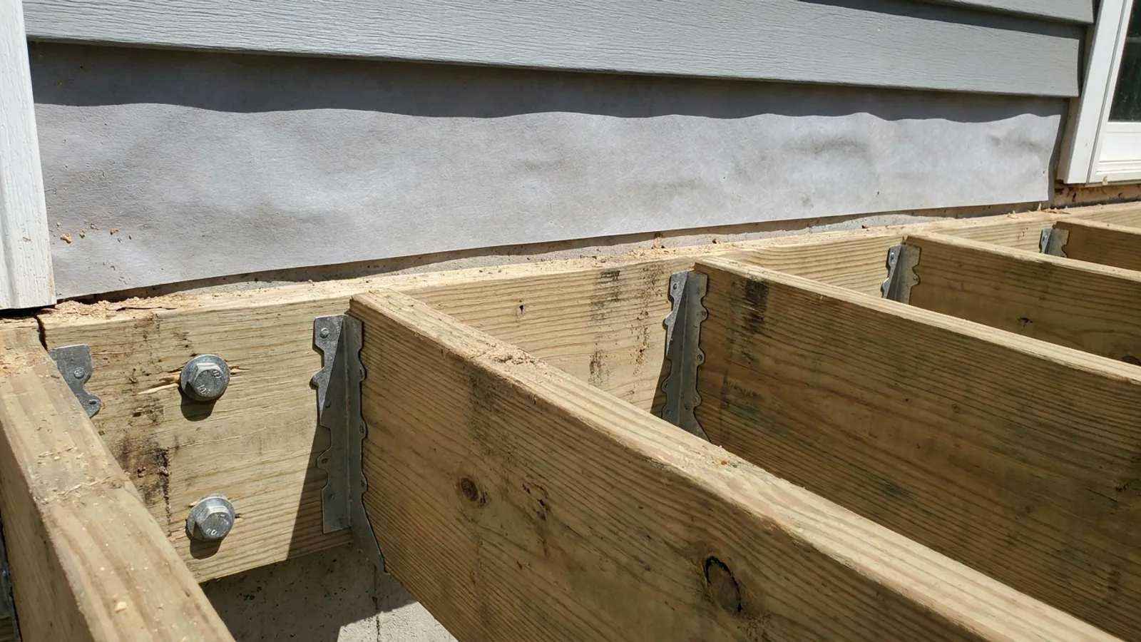 A finished wooden deck attached to the back of a North Carolina home