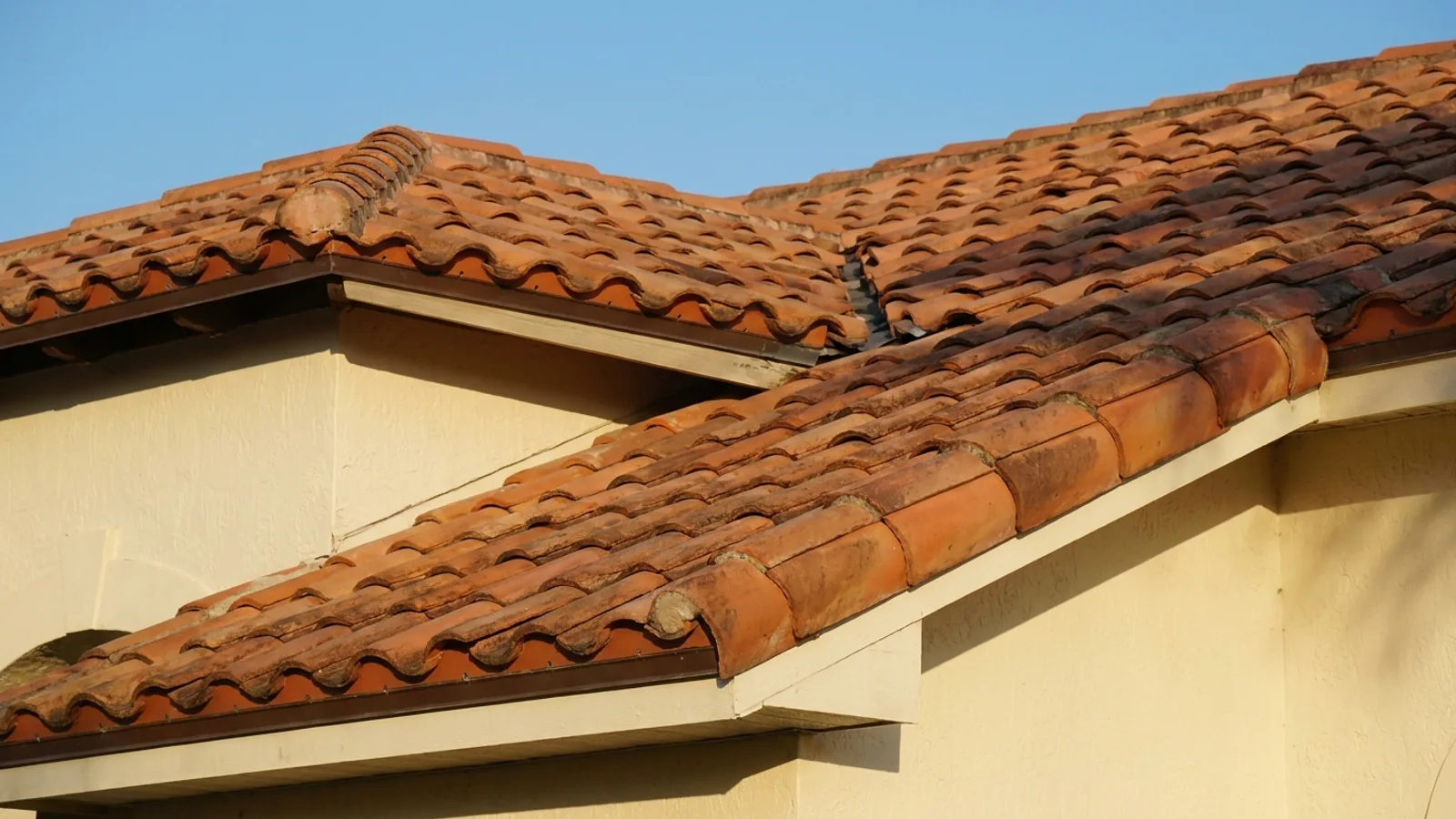A Spanish barrel tile roof on a Florida home under a clear sky